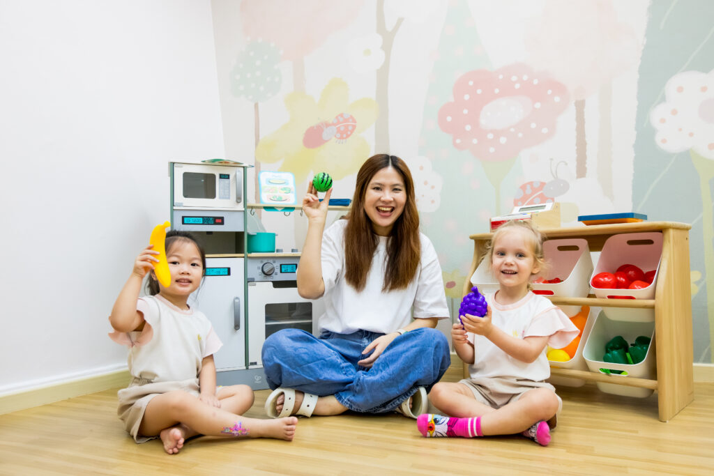 Teacher guiding children in pretend play activities